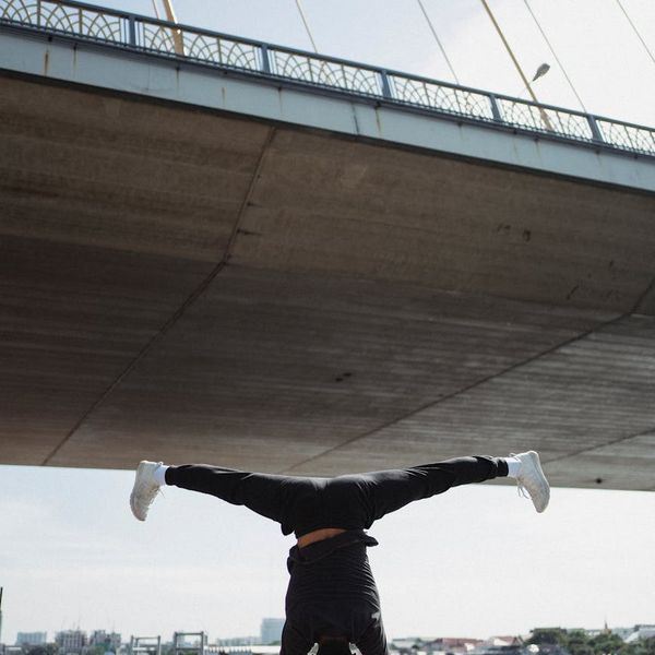 Athlete focused during a bodyweight exercise, demonstrating balance.